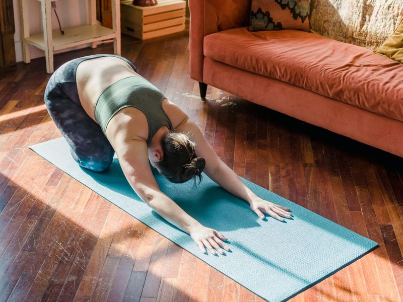Person doing morning yoga routine in minimalist room
